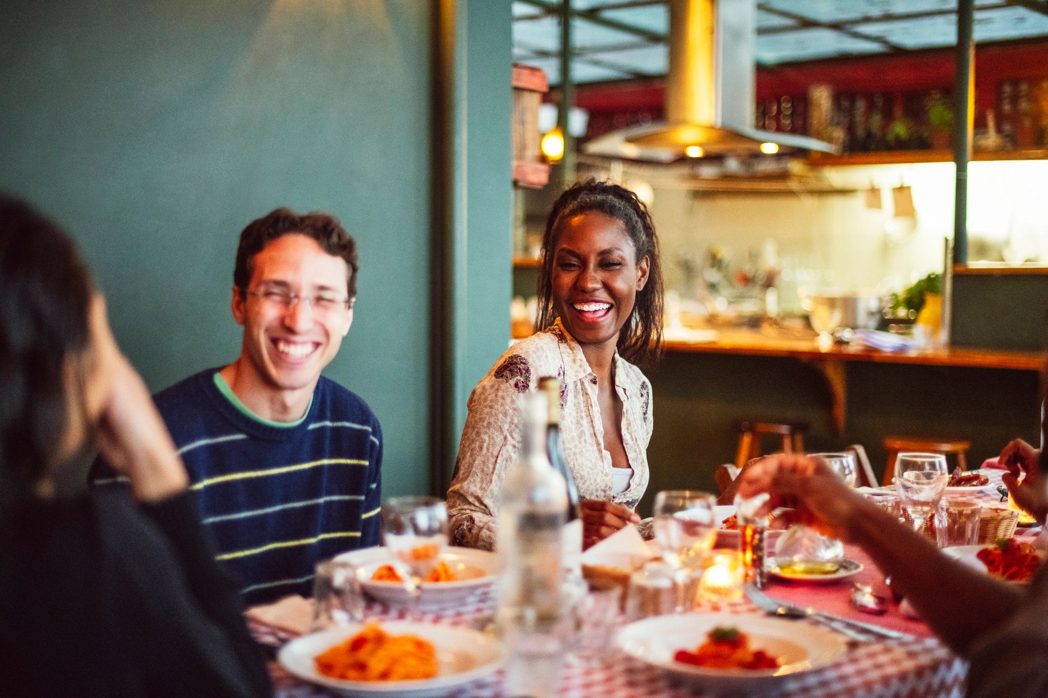 Happy restaurant guests enjoying a meal together